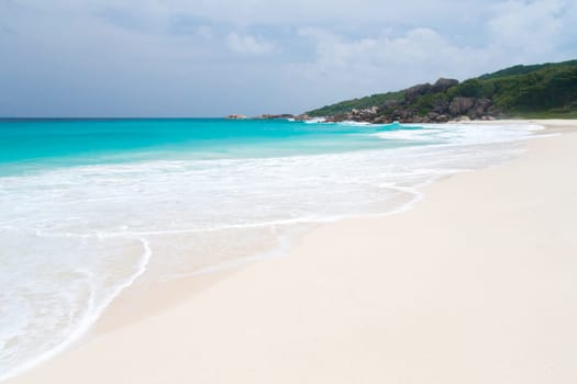 The beach with white sand and turquoise water with waves