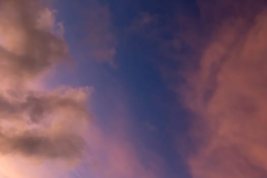 A sky in beautiful colors at sunset with a few clouds