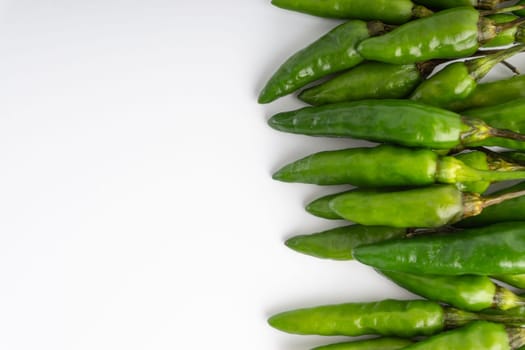 Green Bird’s eye chili,Thai Chili pepper ,bird chili pepper nature isolate on white background. Selective focus and crop fragment