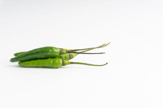 Green Bird’s eye chili,Thai Chili pepper ,bird chili pepper nature isolate on white background. Selective focus and crop fragment