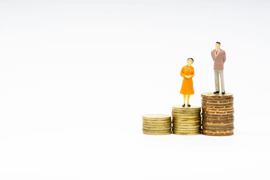 Miniature people standing on stacking coins with white background. Business and Lifestyle concepts.