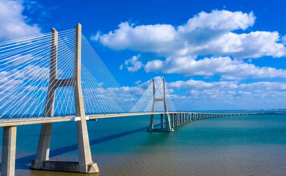 Vasco da Gama Bridge in Lisbon is a famous landmark in the city - aerial drone footage