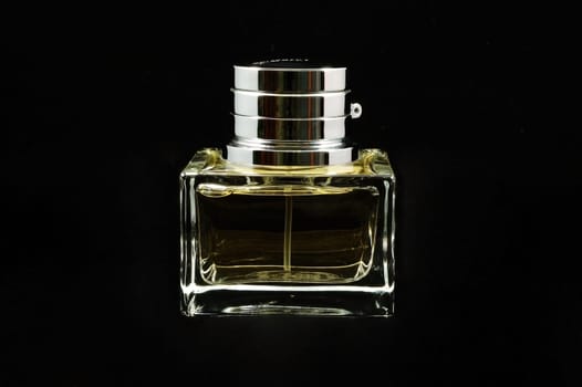 An isolated perfume bottle over black background