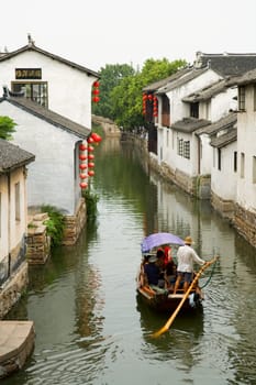 The aerial view of water town in China, with boat man rowing on river