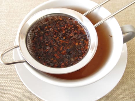 Honey bush tea in a tea sieve