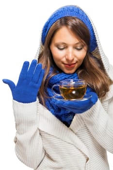 Young woman with dark hair and blue wool lyant drink a cup of tea to be isolated on white background