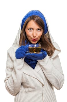 Young woman with dark hair and blue wool lyant drink a cup of tea to be isolated on white background
