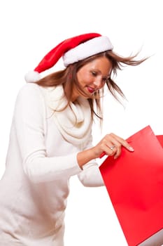 Attractive young woman with Santa hat holds laughing a red shopping bag sale final sale in hand on white background with text free space Insulated freeholder