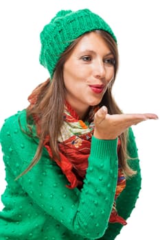 Young attractive woman with green wool hat with kiss mouth throws a kiss to isolated against white background