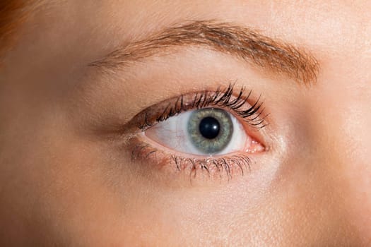 Close-up of a female face with eye lip nose and eyebrows isolated on white background