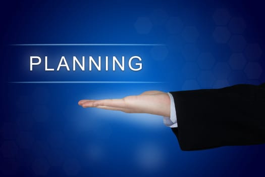 planning button with business hand on blue background