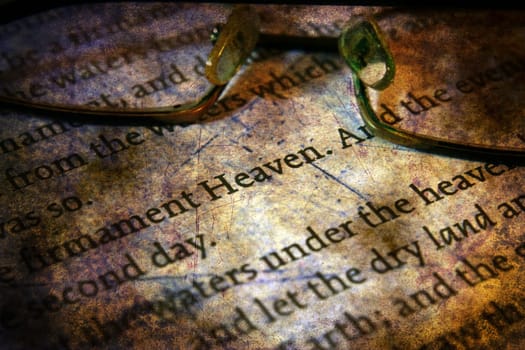 Reading  glasses on bible grunge concept