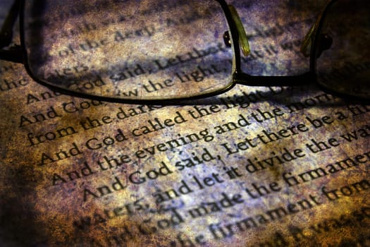Reading  glasses on bible grunge concept