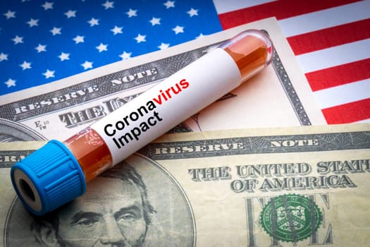 CORONAVIRUS IMPACT text, US Dollar and blood sample vacuum tube on America flags background. Covid-19 or Coronavirus Concept
