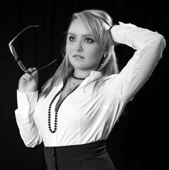 Young blonde business woman with glasses in the hand.