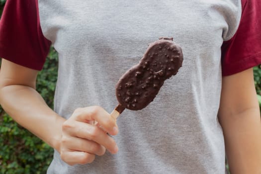 Ice cream covered with chocolate and nuts, stock photo