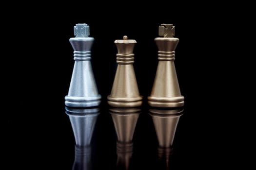 Stacking Piece of chess, king and queen with reflection glass on black background.