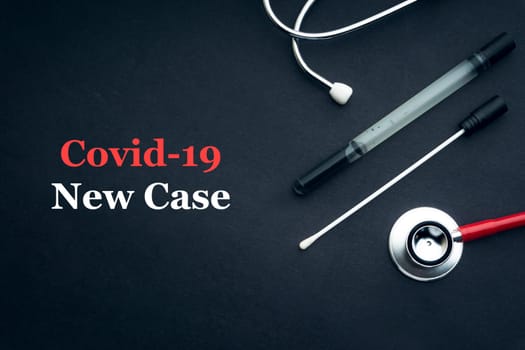 COVID-19 or CORONAVIRUS NEW CASE text with stethoscope and medical swab on black background. Covid-19 or Coronavirus concept.