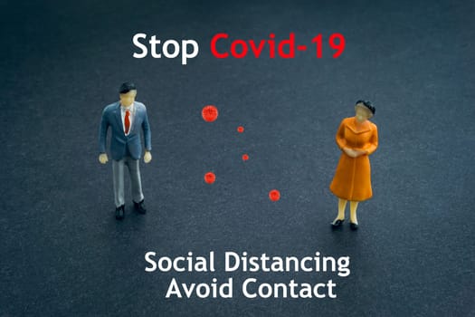 STOP COVID-19 SOCIAL DISTANCING AVOID CONTACT text with miniature people on dark background. Covid-19 or Coronavirus concept