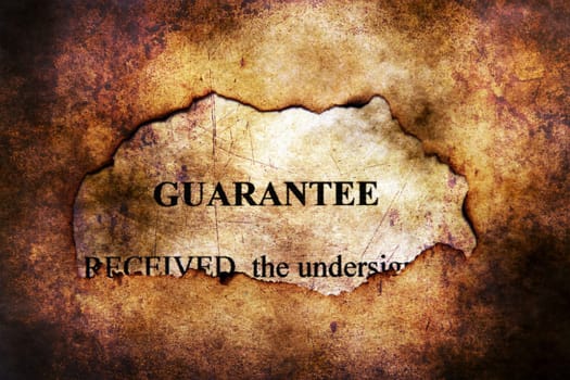 Guarantee text on paper hole grunge concept