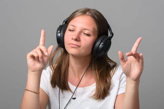 Portrait of a girl listening to music on headphones