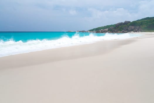 The beach with white sand and turquoise water with waves