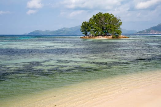 View from the main island to an another island in the near with a lot of plants and blue sky