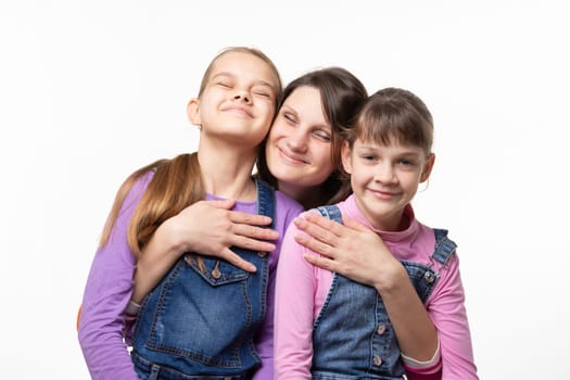 Mom happily clung to her daughters, isolated on white background