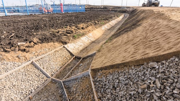 Strengthening the slope and constructing a drainage ditch along the road