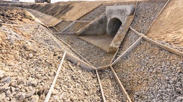 Construction of a drainage ditch along a road with a culvert under the road