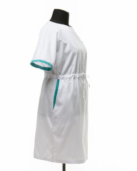Side view of a female medical gown on a mannequin for clothes on a white background