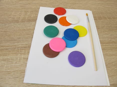 Water-soluble watercolor color tablets - Colorful watercolor, a drawing pad and a brush