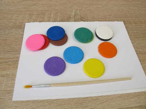 Water-soluble watercolor color tablets - Colorful watercolor, a drawing pad and a brush
