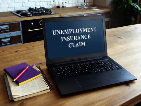 Notebook with open unemployment insurance claim on a table in a house.