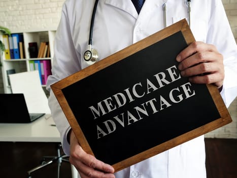 A Doctor shows a tablet Medicare advantage.
