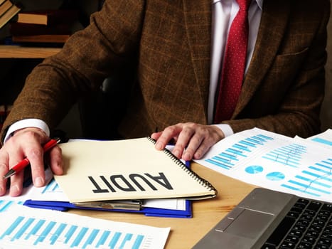 The auditor writes a report on the audit of the company.