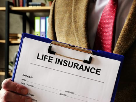 An agent offers a life insurance policy.