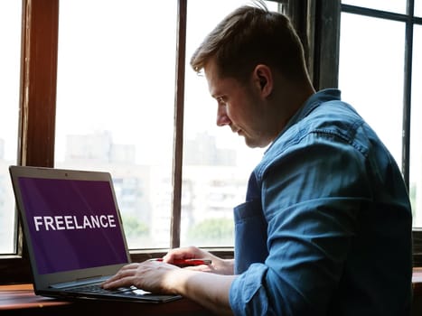 A man is looking for a freelance job on the Internet for a freelancer.
