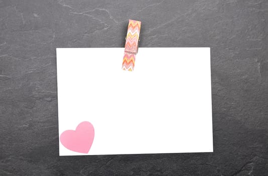 Chit and wooden peg on slate board