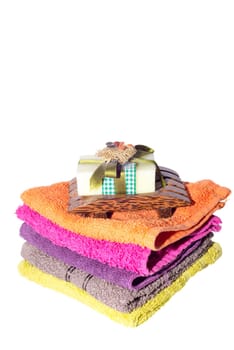 soap and dish on top of facecloths of various shades