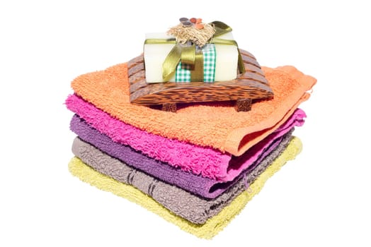 soap and dish on top of facecloths of various shades