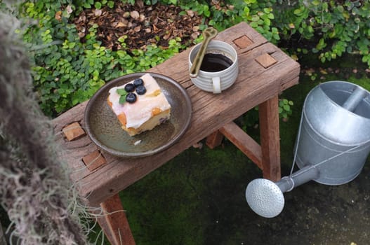 Coffee with piece of cake on wooden table , Concept Relax time, Copy space. Place for text.
