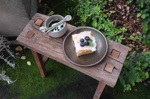 Coffee with piece of cake on wooden table , Concept Relax time, Copy space. Place for text.
