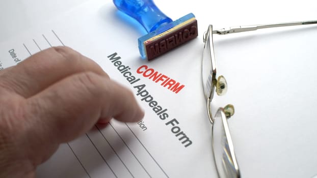 Finger tapping on medical appeals form