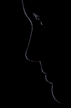 The outline of a young woman's face