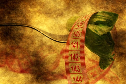 Lettuce and measure tape on fork grunge concept