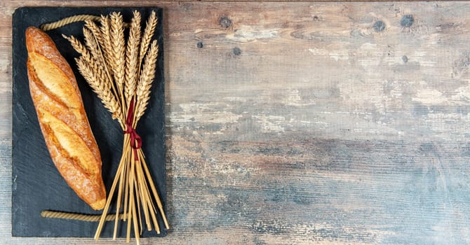 a Baguette or French bread and some wheat ears, copy space