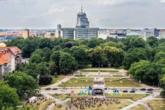 Szczecin, Poland, June 2018 Charity cycling event on Adama Mickiewicza square and city park with Radisson hotel in background.