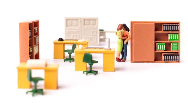 Miniature Lesbian Female Gay Couple, Two tiny People Women Kissing Each other at the office, Concept of Homosexual Relationship.