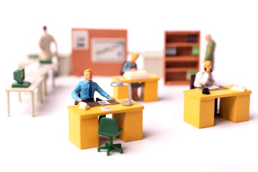 Miniature business people team at the office. Macro shot of Tiny people business concept. Shallow Dept Of Field